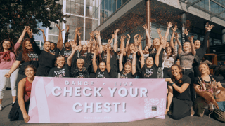 Campaign participants holding a DANCE LIVE CHECK YOUR CHEST banner in London
